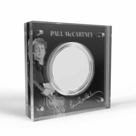 Commemorative coin display with musician photo and signature.